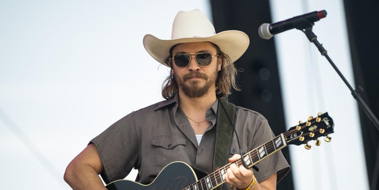 luke grimes on stage at stagecoach festival 2023 with a guitar singing