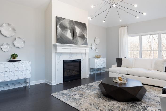 A set of bright white chests flank the fireplace.