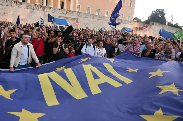 Pro-Eurozone supporters hold a large European Union flag reading 'Yes' during a rally outside the parliament building in Athens, on June 30, 2015