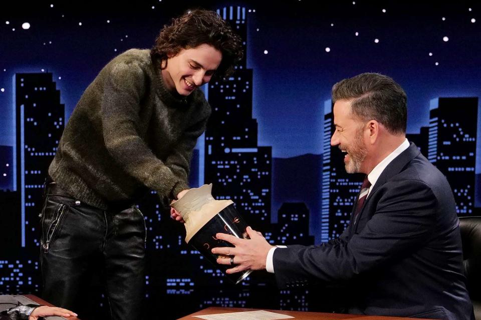 <p>Randy Holmes / Disney via Getty </p> Timothée Chalamet and Jimmy Kimmel with the viral AMC Theaters 
