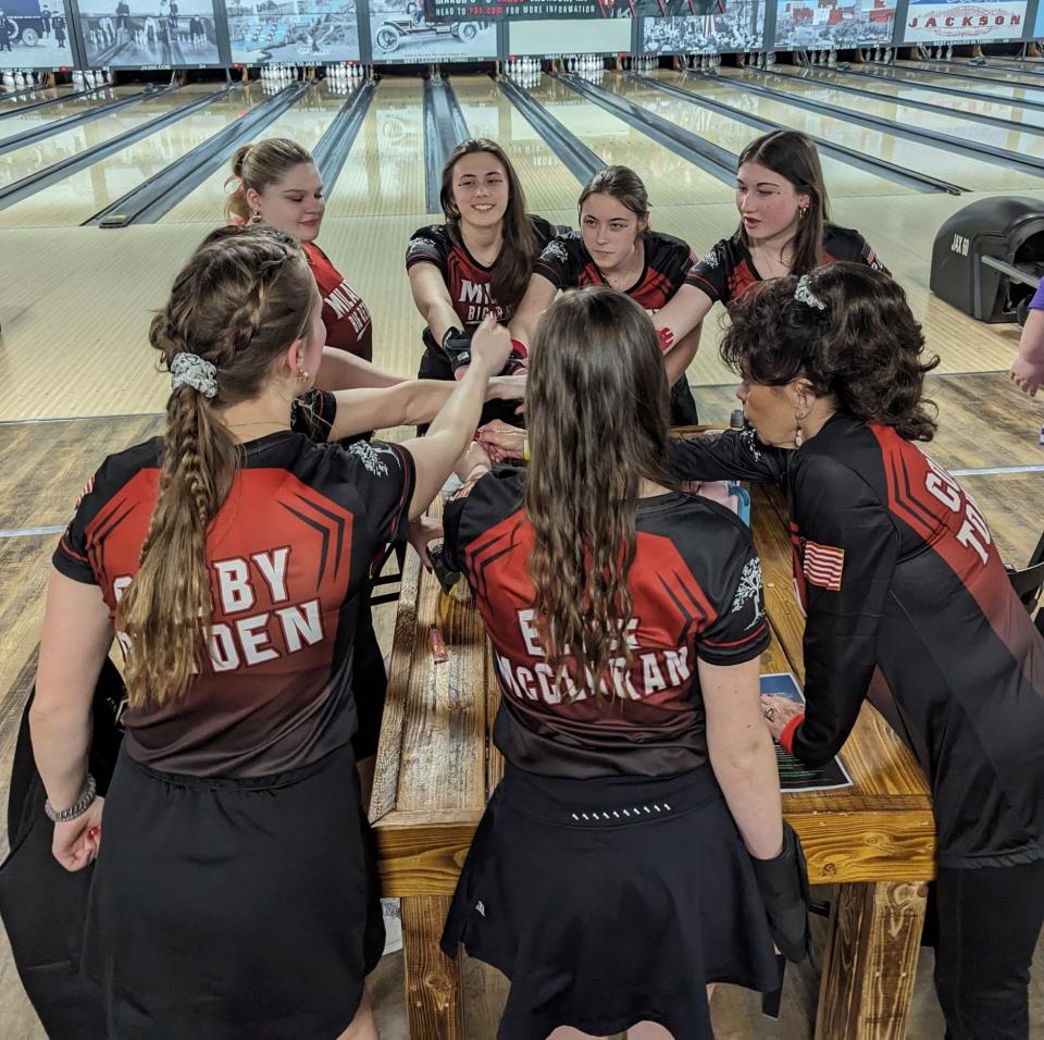 Milan's girls bowling team huddles before the state finas.