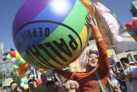 Participants march through a street during a pride parade in Taipei, Taiwan, Saturday, Oct. 31, 2020. (AP Photo/Chiang Ying-ying)