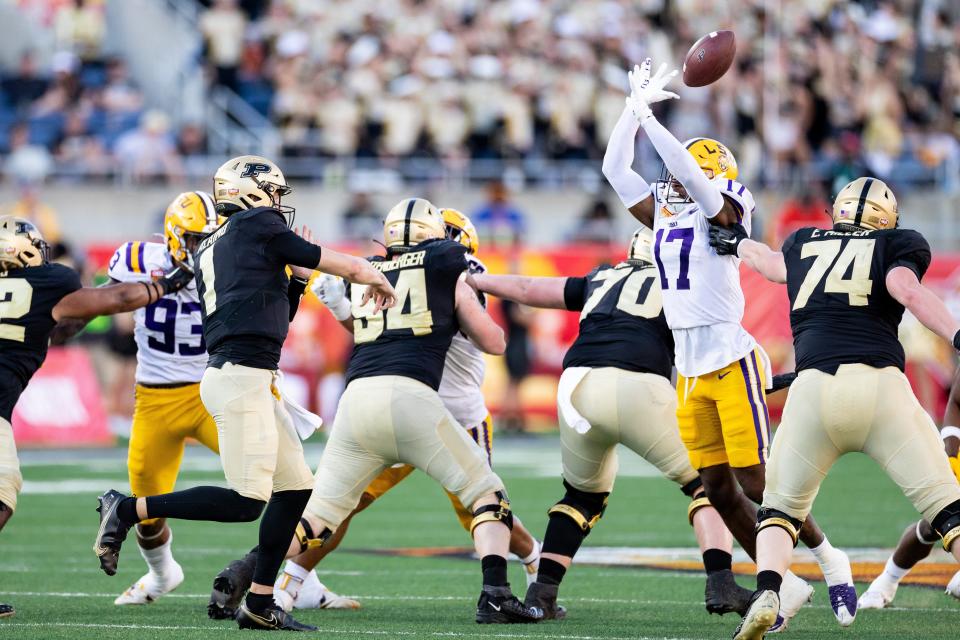 Jan 2, 2023; Orlando, FL, USA; LSU Tigers defensive end Zavier Carter (17) breaks up a pass from Purdue Boilermakers quarterback Michael Alaimo (1) during the second half at Camping World Stadium.