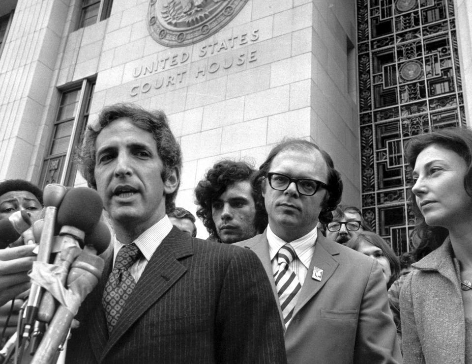 FILE - Daniel Ellsberg speaks to reporters outside the Federal Building in Los Angeles, Jan. 17 1973, as his co-defendant, Anthony Russo, center right, looks on. Ellsberg, the government analyst and whistleblower who leaked the “Pentagon Papers” in 1971, has died. He was 92. (AP Photo, File)