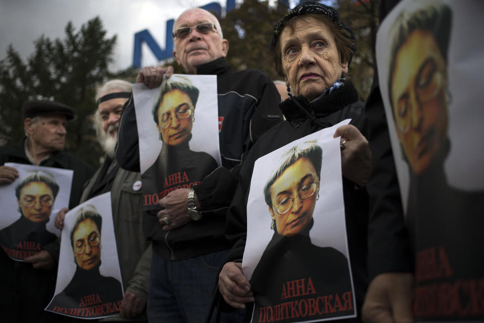 People rally, holding portraits of slain journalist Anna Politkovskaya, in downtown Moscow, Sunday, Oct. 7, 2012. About 200 people rallied Thursday on the 6th anniversary of the killing of Anna Politkovskaya, calling on the authorities to find and punish the killers of journalists and human rights activists in Russia. (AP Photo/Alexander Zemlianichenko)