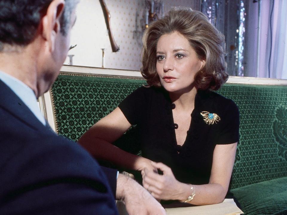 Barbara Walters sitting on a couch and interviewing a man.