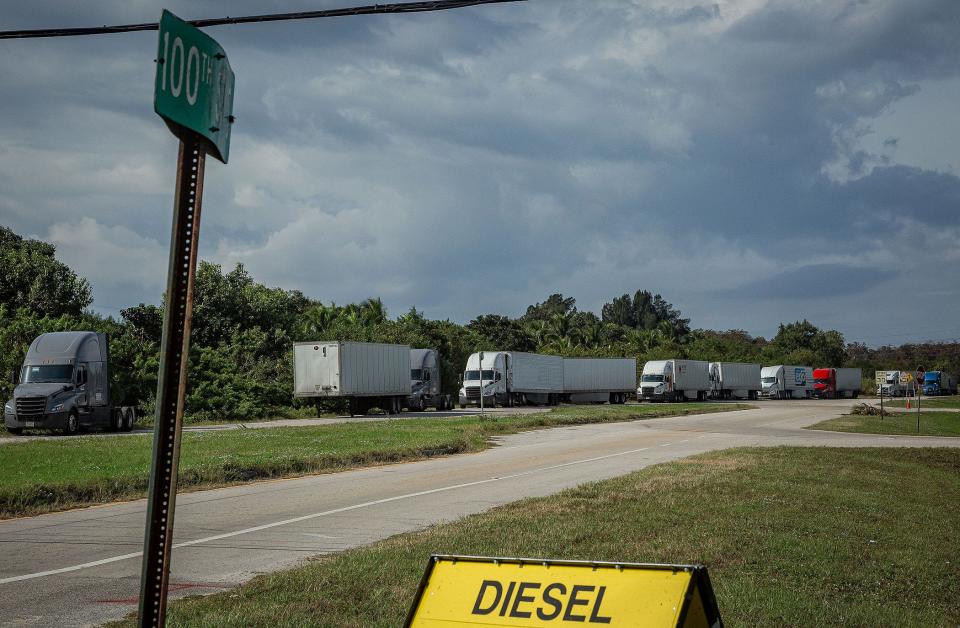 Several tractor-trailers are parked on the south side of 100th Street South near the intersection with US Highway 441 in unincorporated Palm Beach County, on November 24, 2023. The side of the road is not a designated parking area.