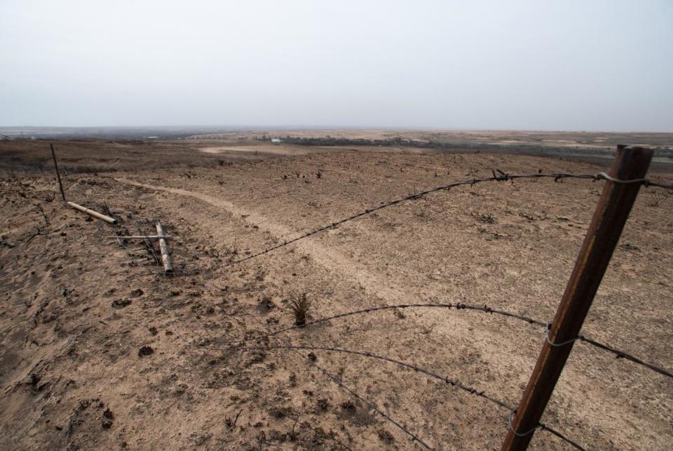 A part of Currie Smith’s fence burned by the Smokehouse Creek fire Sunday, March. 3, 2024, in Hemphill County, Texas.