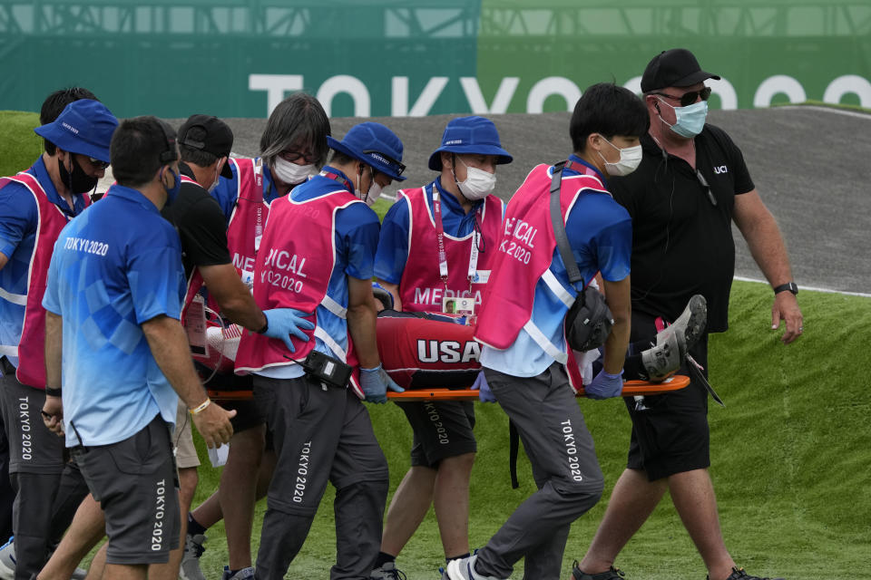 Medics carry away on a stretcher Connor Fields of the United States after he crashed at the first bend in the men's BMX Racing semifinals at the 2020 Summer Olympics, Friday, July 30, 2021, in Tokyo, Japan. (AP Photo/Ben Curtis)