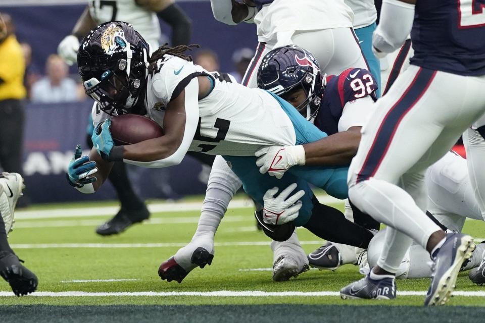 JaMycal Hasty pulls away from a Houston tackler to score a touchdown last season.