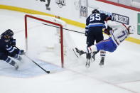 Winnipeg Jets' Mark Scheifele (55) hits Montreal Canadiens' Jake Evans (71) after Evans scored an empty-net goal during the third period of Game 1 of an NHL hockey Stanley Cup second-round playoff series Wednesday, June 2, 2021, in Winnipeg, Manitoba. (John Woods/The Canadian Press via AP)