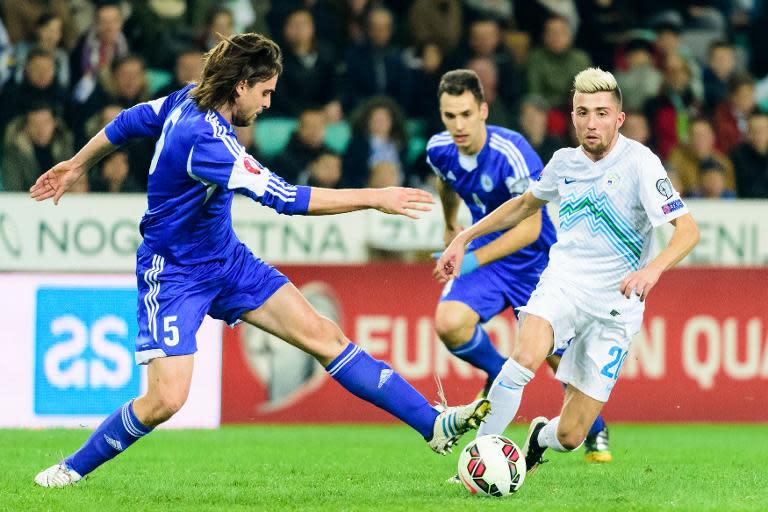 Slovenia's midfielder Kevin Kampl (R) challenges San Marino's defender Davide Simoncini during the Euro 2016 qualifying group E football match between Slovenia and San Marino at the Stozice Stadium in Ljubljana on March 27, 2015