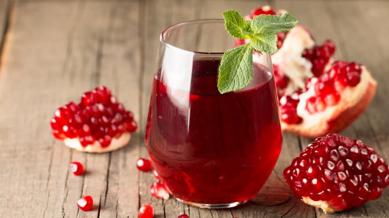 Glass of pomegranate juice and pomegranate fruit