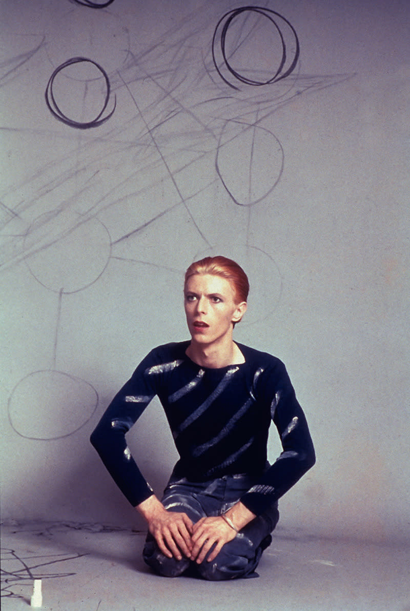 “David seated drawing circles on the background paper and then the Kabbalah Tree of Life diagram on the floor. Los Angeles, 1974.”