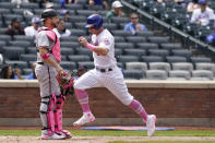 New York Mets James McCann, right, scores on Francisco Lindor's sacrifice fly during a baseball game against the Arizona Diamondbacks, Sunday, May 9, 2021, in New York. Diamondbacks catcher Stephen Vogt, left, looks on. (AP Photo/Kathy Willens)