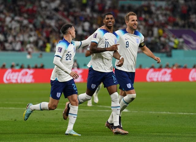 Marcus Rashford, centre, celebrates a World Cup goal against Iran with Harry Kane, right, and Phil Foden