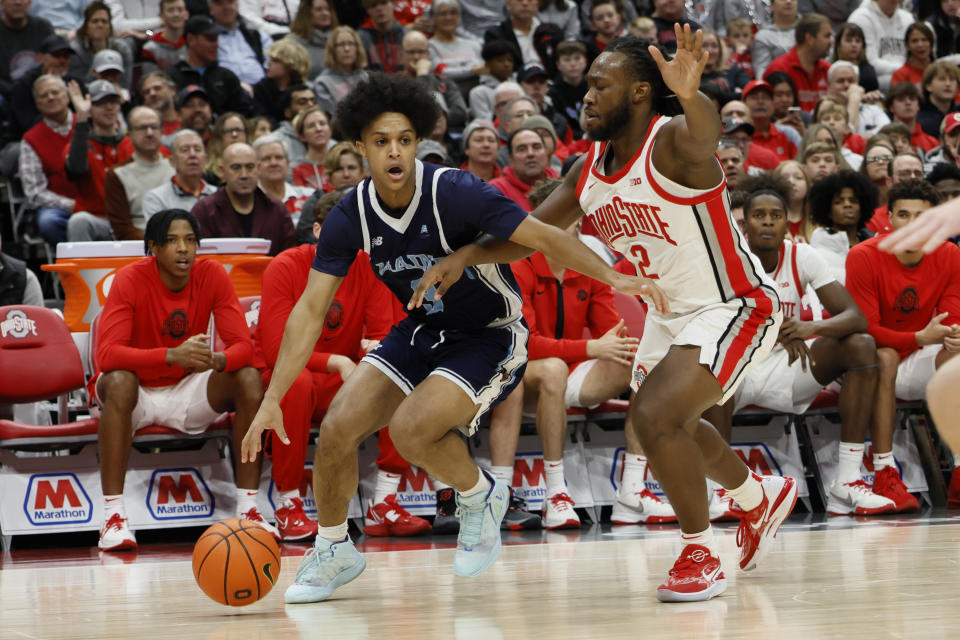 Maine's Jaden Clayton, left, drives the baseline against Ohio State's Bruce Thornton during the first half of an NCAA college basketball game on Wednesday, Dec. 21, 2022, in Columbus, Ohio. (AP Photo/Jay LaPrete)