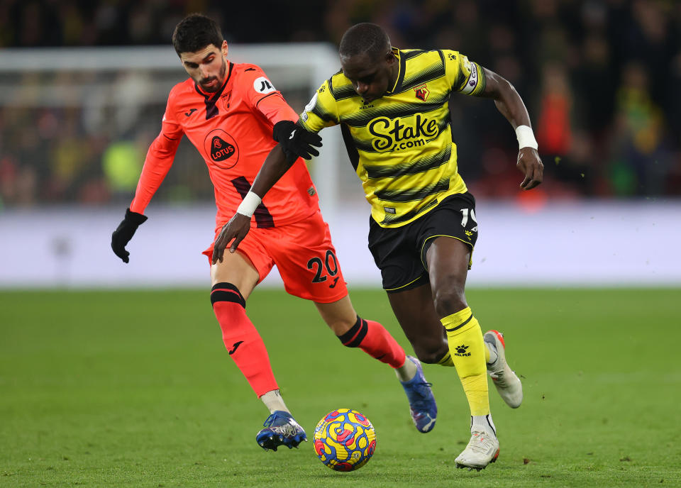 WATFORD, ENGLAND - JANUARY 21: Moussa Sissoko of Watford holds off Pierre Lees-Melou of Norwich City during the Premier League match between Watford and Norwich City at Vicarage Road on January 21, 2022 in Watford, England. (Photo by Catherine Ivill/Getty Images)