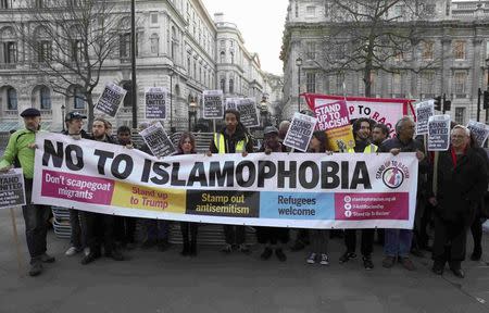 Demonstrators hold a banner opposite Downing Street, London, Britain March 24, 2017. REUTERS/Neil Hall