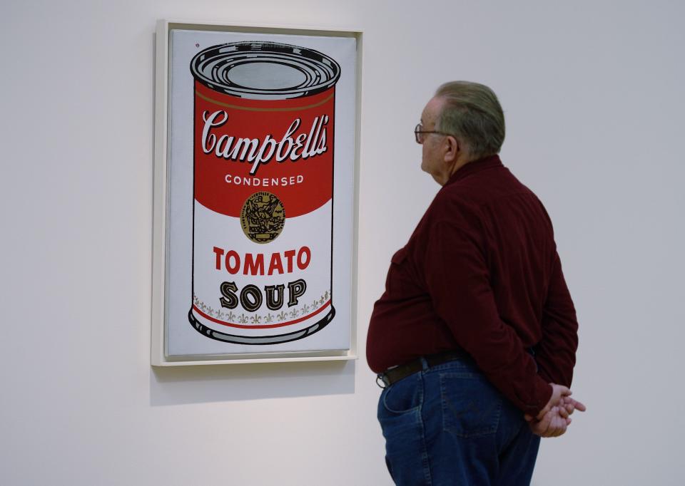 A man views the painting Large Campbell's Soup Can by Andy Warhol at Sotheby's before a 2016 auction in New York.