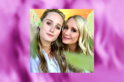Kim Richards and Whitney White take a photo together overlaid onto a pink background.