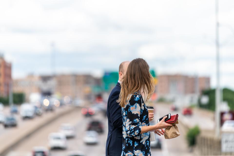 Colleagues walk with coffee in Dallas, Texas.