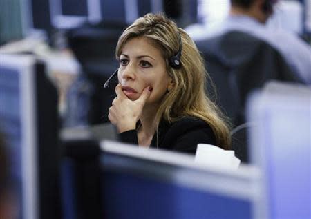 A worker on IG Index's trading floor looks at her computer screens as markets tumble globally, in London September 22, 2011. REUTERS/Andrew Winning