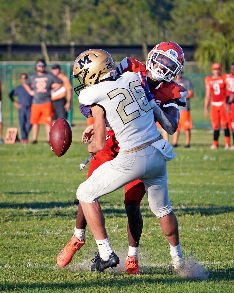 University's Noble Thomas (1) forces the fumble on Monarchs punter during a game in Deltona, Thursday, August 19, 2021.