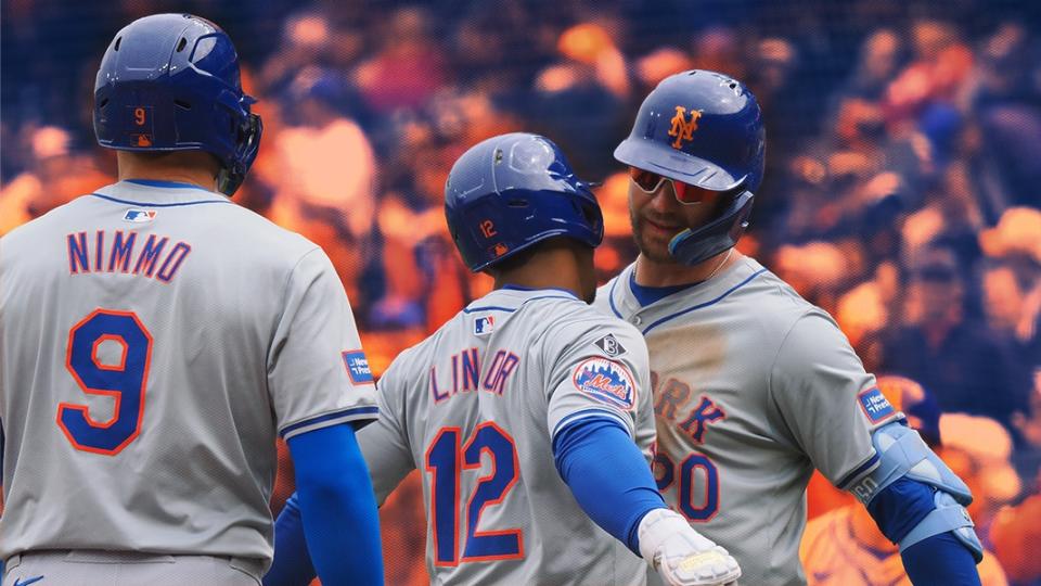 Pete Alonso and Francisco Lindor celebrate with a chest bump with Brandon Nimmo in the foreground