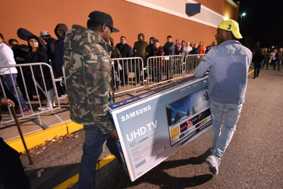 Shoppers leave with television sets at Best Buy in Connecticut (AFP/Getty Images)