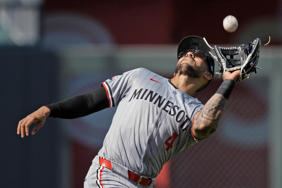 Minnesota Twins shortstop Carlos Correa (4) catches a fly ball for the out on Kansas City Royals' Salvador Perez during the second inning of a baseball game Saturday, March 30, 2024, in Kansas City, Mo. (AP Photo/Charlie Riedel)