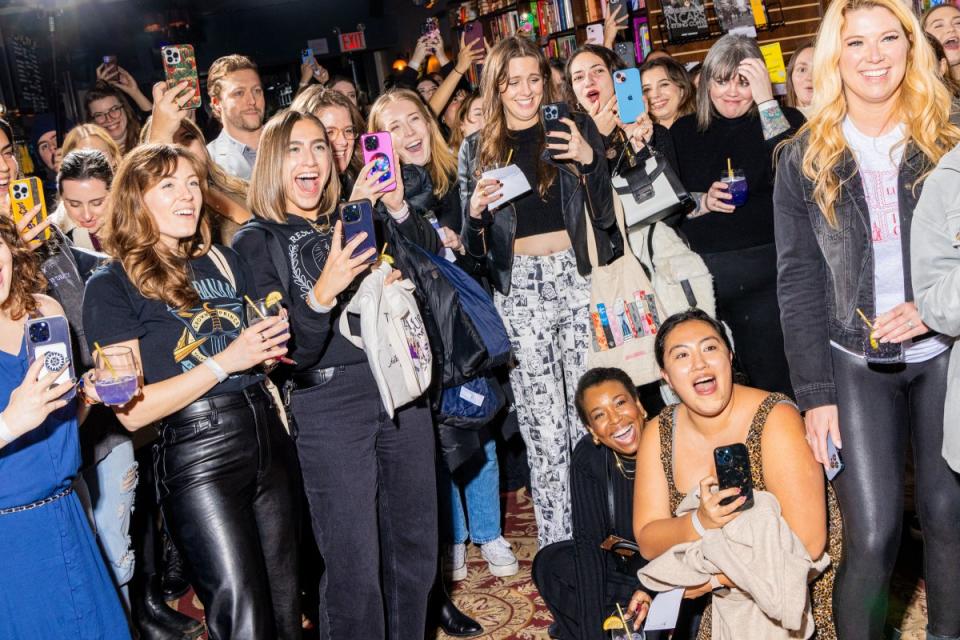 Fans of Maas’ books take photos at Book Club Bar.<span class="copyright">Evan Angelastro for TIME</span>