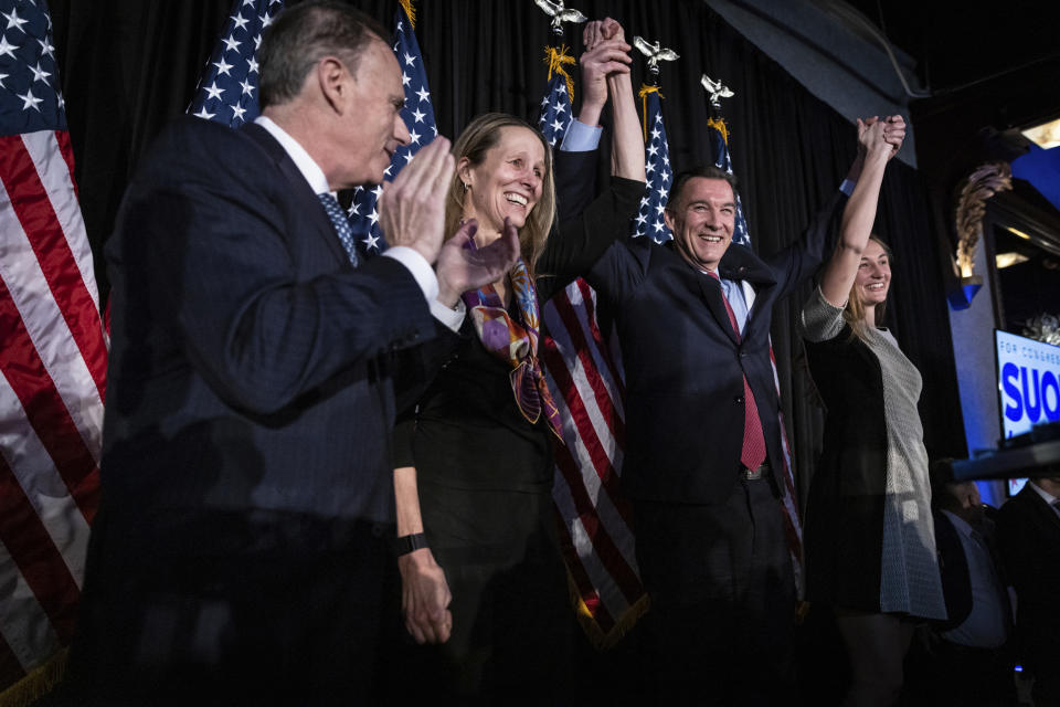 Former U.S. Rep. Tom Suozzi, second from right, Democratic candidate for New York's 3rd congressional district, gestures at his election night party Tuesday, Feb. 13, 2024, in Woodbury, N.Y. Suozzi won a special election for the House seat formerly held by George Santos. (AP Photo/Stefan Jeremiah)