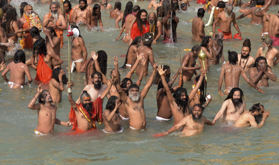 Naga Sadhu or Naked Hindu holy men take holy dips in the river Ganges during Shahi snan or a Royal bath to mark Maha Shivratri festival during Kumbh mela, in Haridwar in the Indian state of Uttarakhand, Thursday, March 11, 2021. (AP Photo)