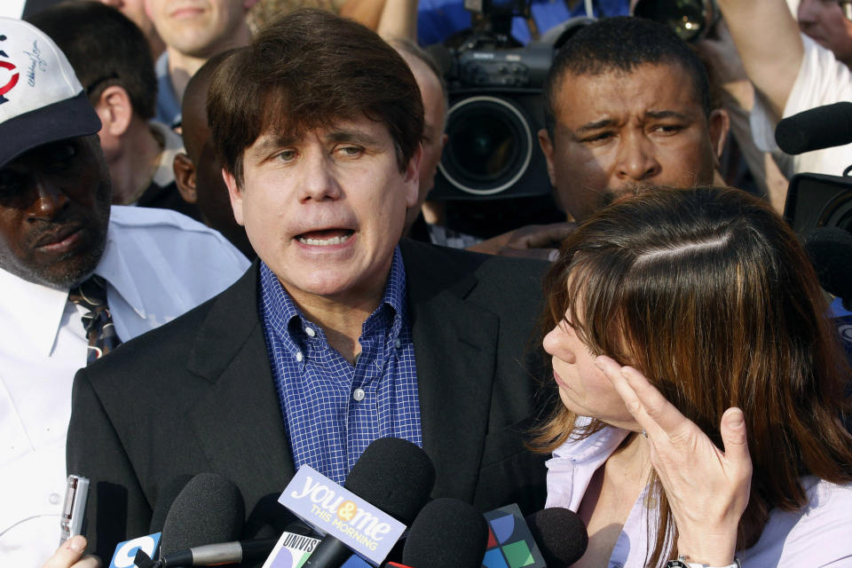 FILE - Former Illinois Gov. Rod Blagojevich speaks to the media outside his home in Chicago as his wife, Patti, wipes away tears a day before reporting to prison after his conviction on corruption charges, March 14, 2012. Serving his second term, Blagojevich was arrested in 2008 and accused of trying to sell the Senate seat that Barack Obama vacated when he won the White House. He was convicted and sentenced to 14 years in federal prison — until Trump commuted his sentence in 2020. (AP Photo/M. Spencer Green, File)