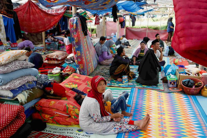 Locals are sheltered in a makeshift tent after Monday's earthquake hit Cianjur