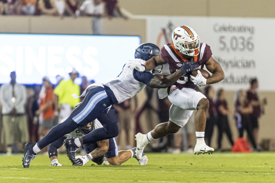 Virginia Tech's Bhayshul Tuten gets away from an Old Dominion defender during the first half of an NCAA college football Saturday, Sept. 2, 2023, in Blacksburg, Va. (AP Photo/Robert Simmons)