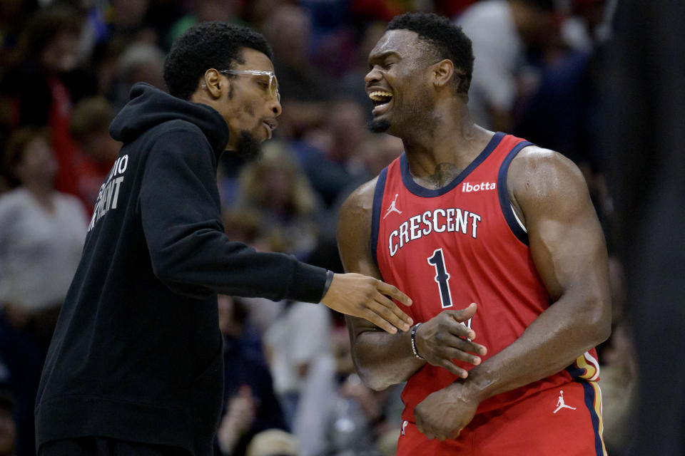 New Orleans Pelicans forward Zion Williamson (1) celebrates with forward Herbert Jones after making a shot against the Portland Trail Blazers during the final seconds of the first half of an NBA basketball game in New Orleans, Saturday, March 16, 2024. (AP Photo/Matthew Hinton)