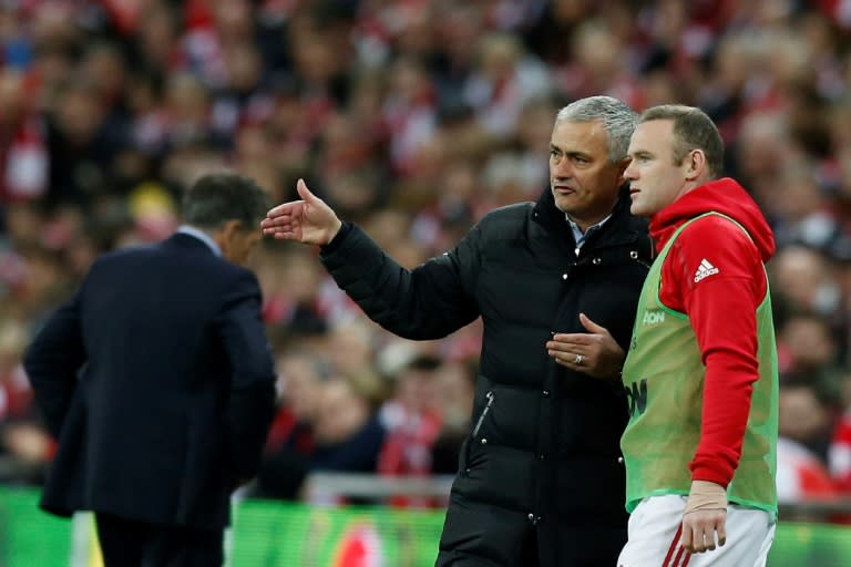 Manchester United's manager Jose Mourinho (L), pictured in February 2017, has said that Wayne Rooney (R) will "100 percent be with us" until the end of this season, but he can't say with certainty where Rooney will be next year