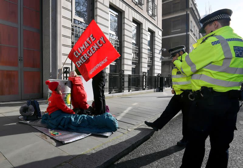 Greenpeace climate activists attempt to block the entrance to BP's head office in London