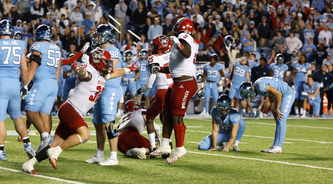 North Carolina place kicker Noah Burnette (98) reacts after he missed the field goal to give the Wolfpack the victory during overtime of N.C. State’s 30-27 overtime victory over UNC at Kenan Stadium in Chapel Hill, N.C., Friday, Nov. 25, 2022. Ethan Hyman/ehyman@newsobserver.com