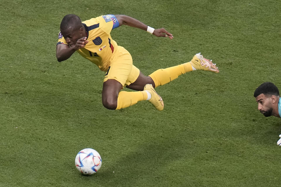 Ecuador's Enner Valencia, left, is fouled by Qatar's goalkeeper Saad Al Sheeb during the World Cup group A soccer match between Qatar and Ecuador at the Al Bayt Stadium in Al Khor, Qatar, Sunday, Nov. 20, 2022. (AP Photo/Hassan Ammar)