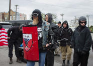 <p>A member of the National Socialist Movement holds a shield and a microphone stand before a “White Lives Matter” rally in Shelbyville, Tenn., on Oct. 27, 2017. (Photo: Emily Molli/NurPhoto via Getty Images) </p>