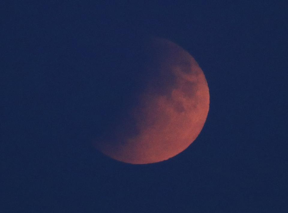 A partial lunar eclipse, visible above London from Primrose Hill (PA)