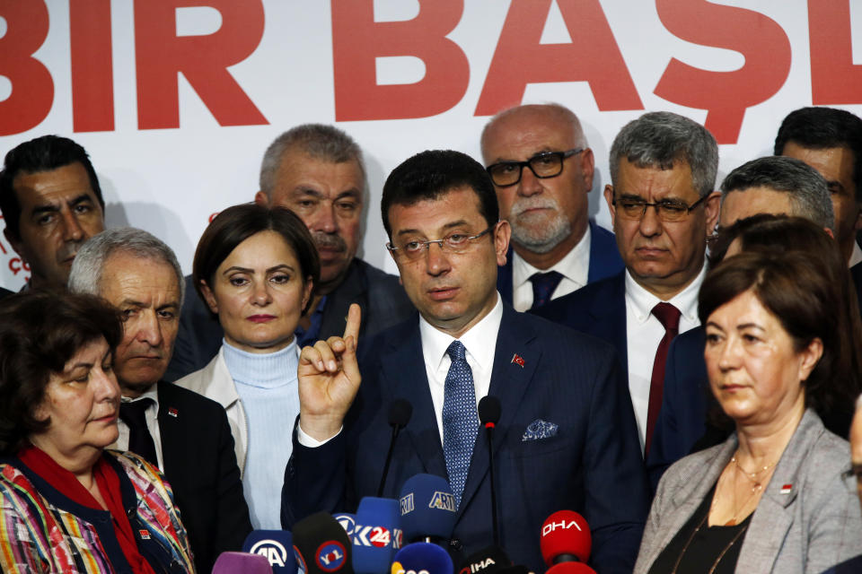 Ekrem Imamoglu, centre, the opposition, Republican People's Party's (CHP) mayoral candidate in Istanbul, talks to members of the media, in Istanbul, Tuesday, April 9, 2019. Turkey's President Recep Tayyip Erdogan's ruling Justice and Development Party, or AKP, says it will seek a re-run of last week's mayoral election in Istanbul, citing alleged irregularities. The party suffered a major setback in the elections. Opposition candidates won in Turkey's capital, Ankara, and squeezed out the ruling party in Istanbul. (AP Photo/Lefteris Pitarakis)