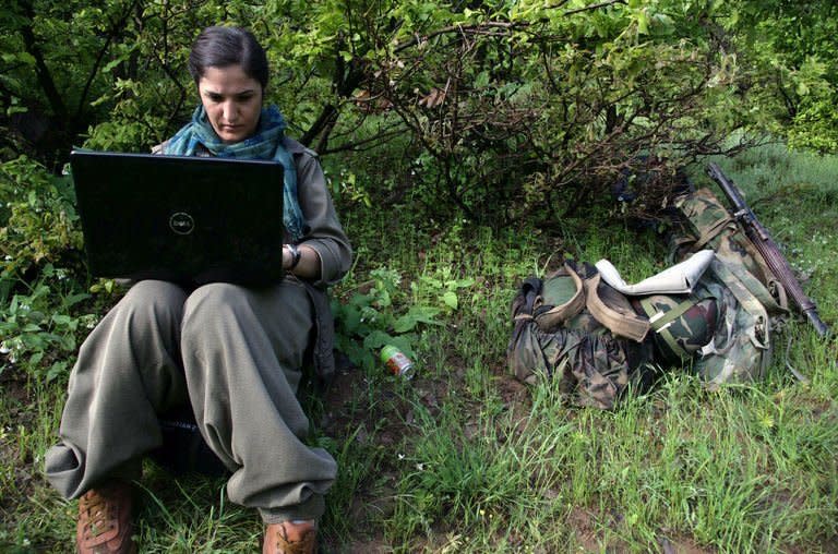 A female Kurdistan Workers' Party (PKK) fighter works on a laptop after arriving in Dohuk, northern Iraq, May 14, 2013. A first group of Kurdish fighters pulling out of Turkey under the terms of a truce arrived in the autonomous Kurdish region of neighbouring Iraq to handshakes and embraces after a gruelling week-long journey