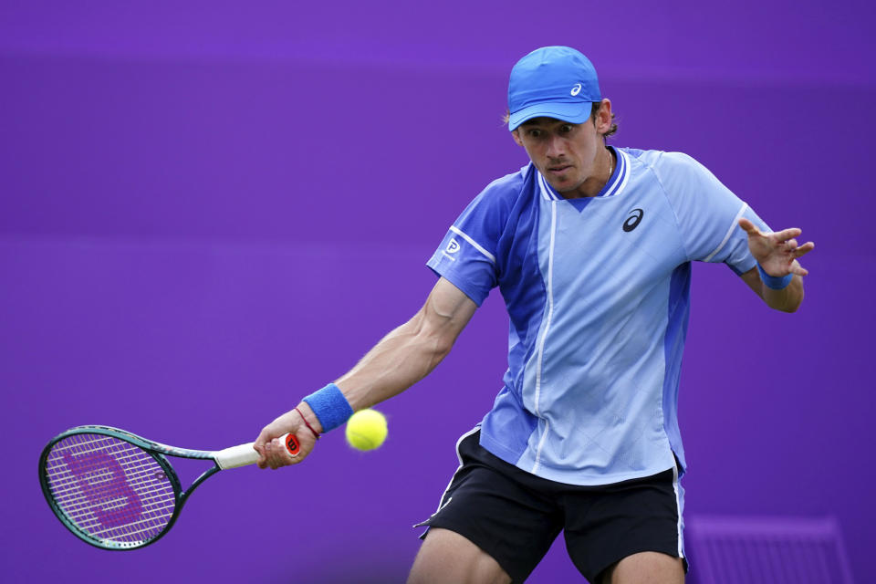 Australia's Alex de Minaur returns the ball to Italy's Lorenzo Musetti during their men's singles match on day four of The Queen's Club tennis tournament, in London, Tuesday, June 18, 2024. (Zac Goodwin/PA via AP)