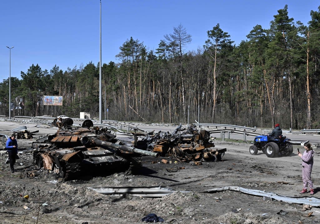 A burnt Russian tank on a road west of Kyiv (AFP via Getty Images)