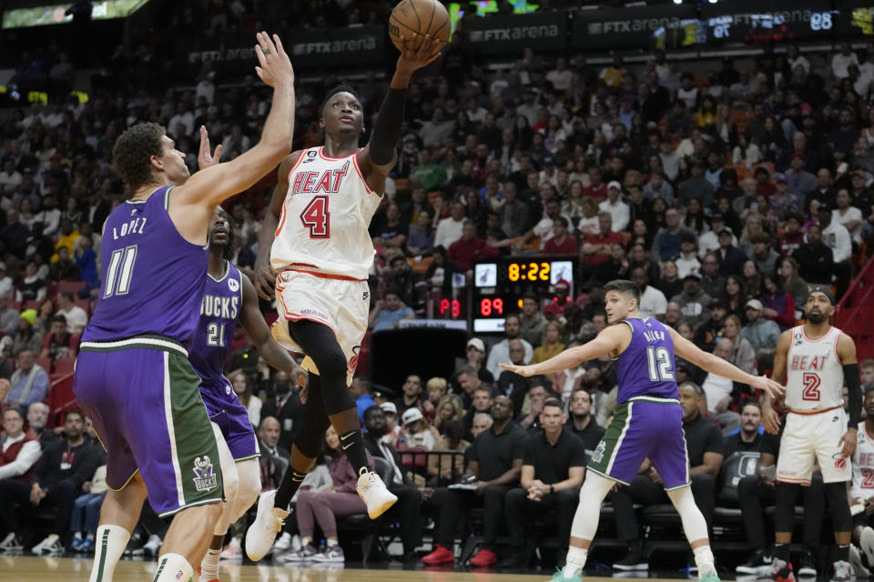 Miami Heat guard Victor Oladipo (4) goes to the basket as Milwaukee Bucks center Brook Lopez (11) defends during the second half of an NBA basketball game, Saturday, Jan. 14, 2023, in Miami. Miami won 111-95. (AP Photo/Lynne Sladky)