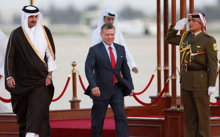 Jordan's King Abdullah II welcomes Qatari Emir Sheikh Tamim bin Hamad al-Thani during a reception ceremony at the Queen Alia International Airport in Amman, Jordan March 28, 2017. REUTERS/Muhammad Hamed